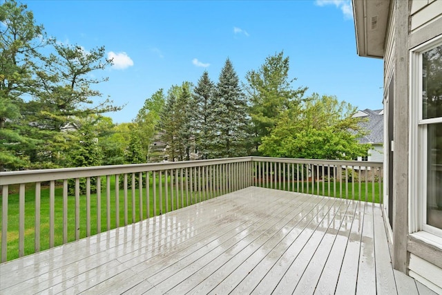 wooden terrace featuring a lawn