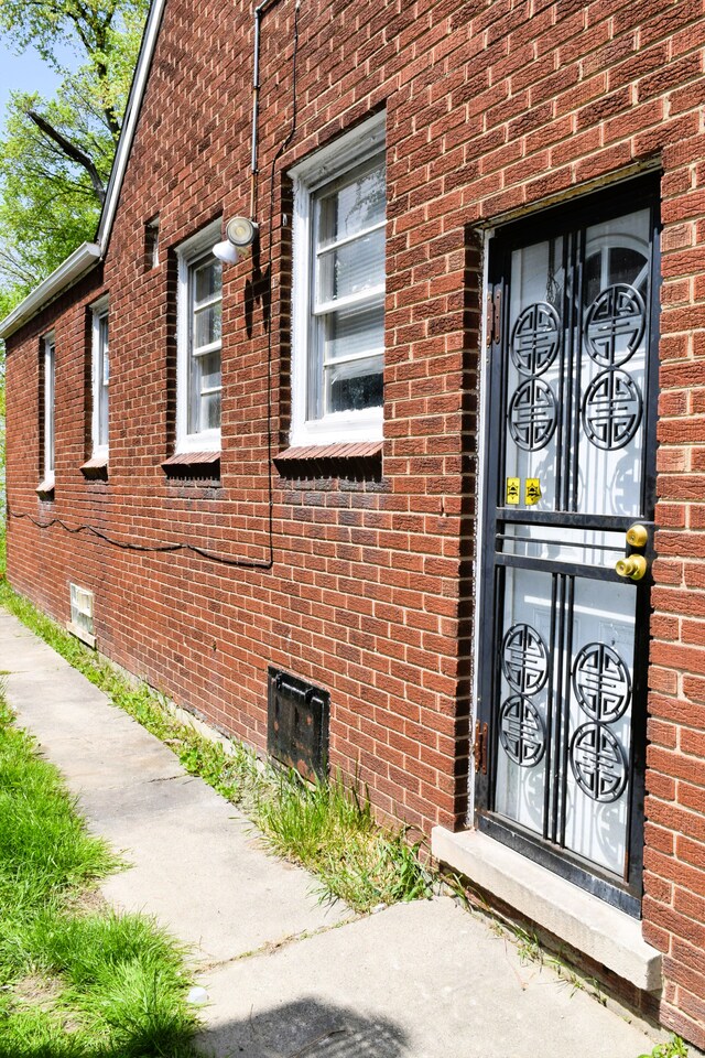 10039 Mark Twain St, Detroit, MI 48227 - view of exterior entry featuring brick siding and crawl space