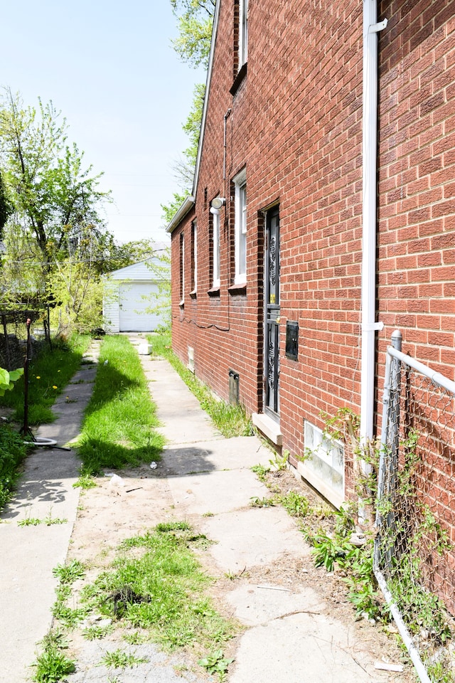 10039 Mark Twain St, Detroit, MI 48227 - view of side of home with brick siding and an outdoor structure