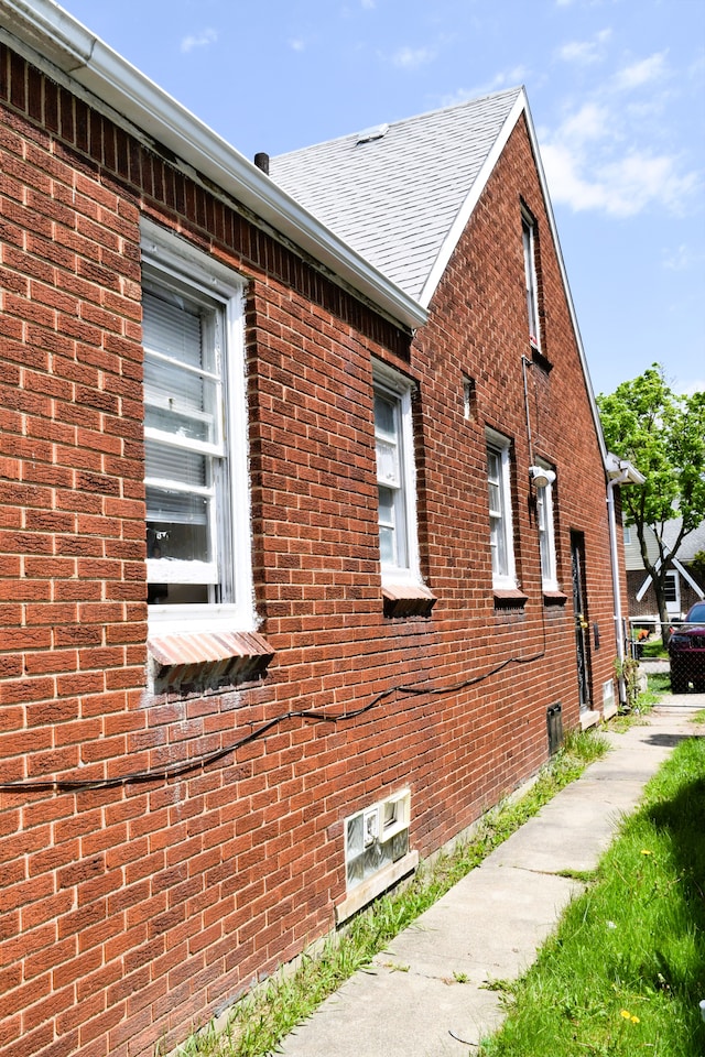 10039 Mark Twain St, Detroit, MI 48227 - view of side of property with a shingled roof and brick siding