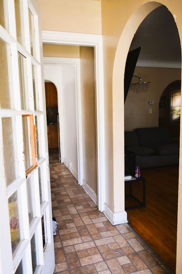 10039 Mark Twain St, Detroit, MI 48227 - hall with arched walkways, brick floors, and baseboards