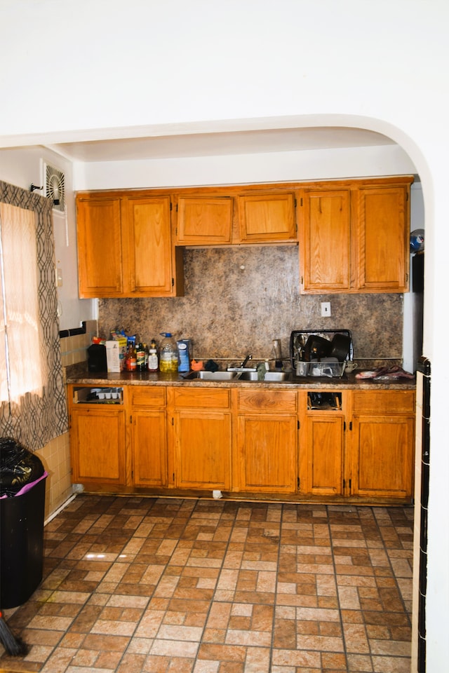 10039 Mark Twain St, Detroit, MI 48227 - kitchen featuring a sink, dark countertops, tasteful backsplash, and brick patterned flooring