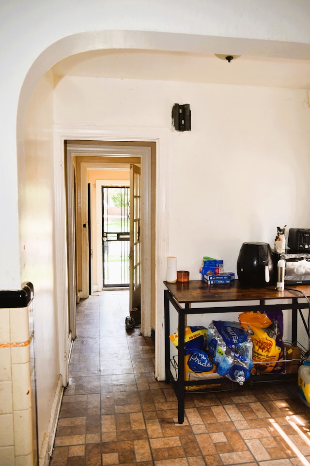 10039 Mark Twain St, Detroit, MI 48227 - hallway featuring brick patterned floors and arched walkways