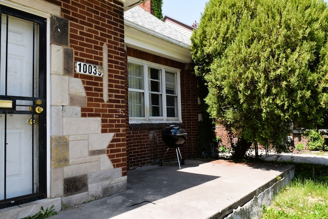 10039 Mark Twain St, Detroit, MI 48227 - entrance to property featuring brick siding and a patio