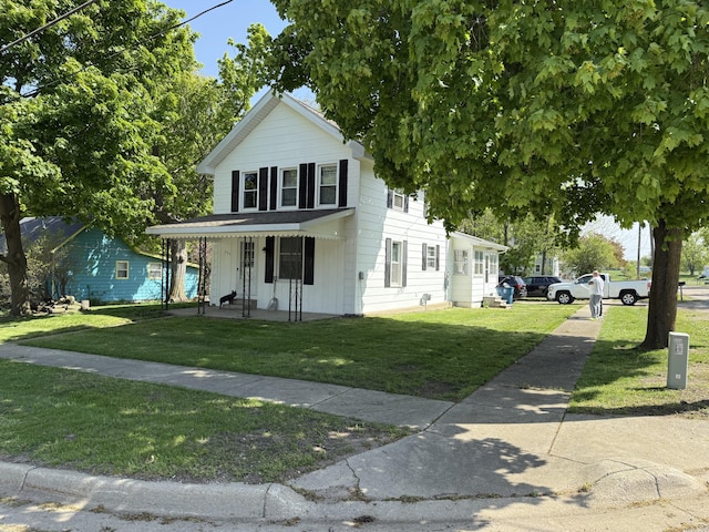202 Kalamo St, Olivet, MI 49076 - view of front facade with covered porch and a front lawn
