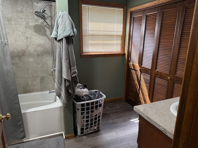 202 Kalamo St, Olivet, MI 49076 - full bath featuring vanity, baseboards, tub / shower combination, wood finished floors, and a closet