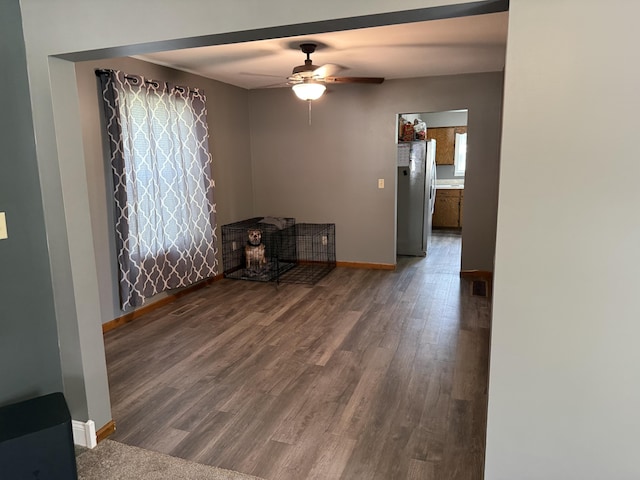 202 Kalamo St, Olivet, MI 49076 - unfurnished room featuring wood finished floors, ceiling fan, and baseboards