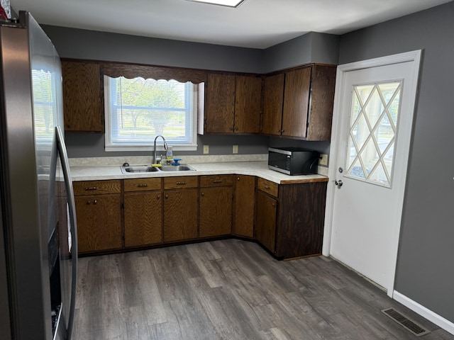 202 Kalamo St, Olivet, MI 49076 - kitchen with stainless steel fridge, a sink, light countertops, and dark wood-style flooring