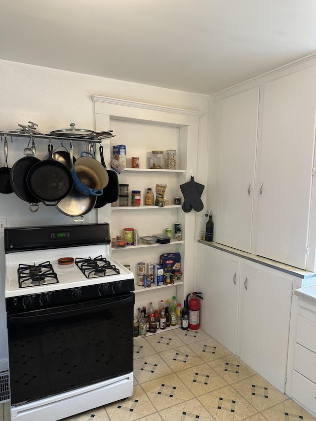522 N Main St, Ann Arbor, MI 48104 - kitchen featuring gas range oven, white cabinetry, and light countertops