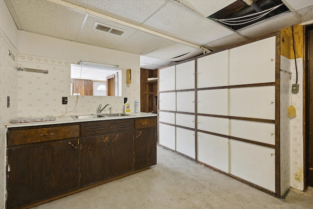 below grade area featuring a sink and a paneled ceiling