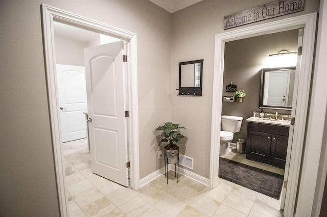 3817 Timber Green Ct, Howell, MI 48843 - hall featuring baseboards, a sink, and light marble finish flooring