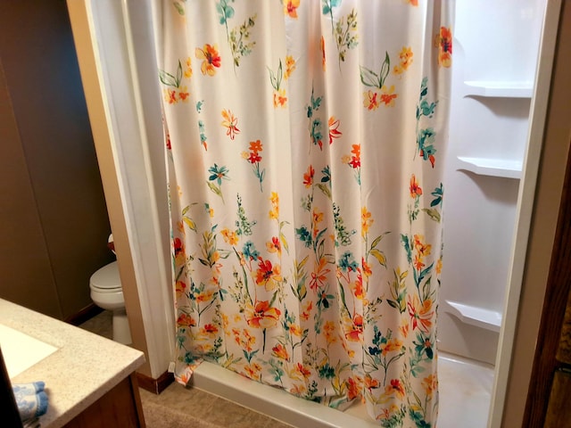 bathroom with a shower with curtain, toilet, vanity, and tile patterned floors