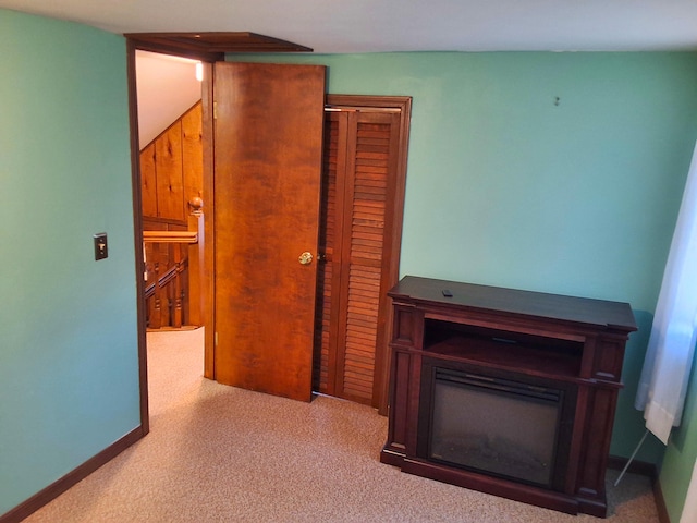 hallway featuring an upstairs landing and baseboards