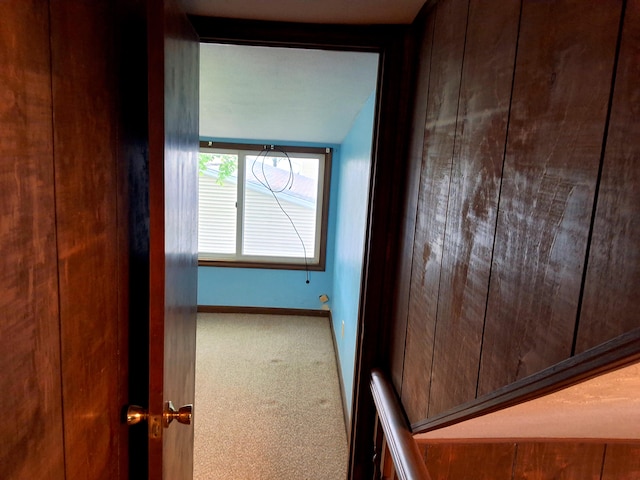 corridor with carpet floors and baseboards