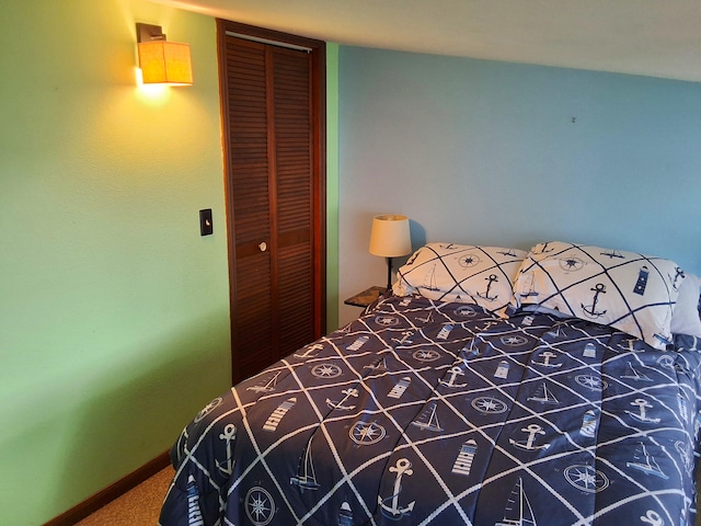 bedroom featuring a closet, carpet floors, and baseboards