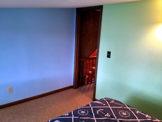 carpeted bedroom featuring baseboards