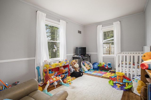 77 S Sprague St, Coldwater, MI 49036 - recreation room featuring healthy amount of natural light, wood finished floors, and ornamental molding