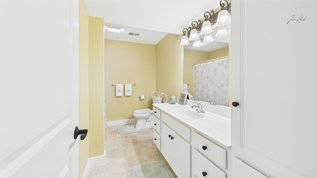 bathroom featuring vanity, toilet, and baseboards