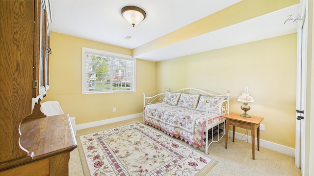carpeted bedroom featuring baseboards