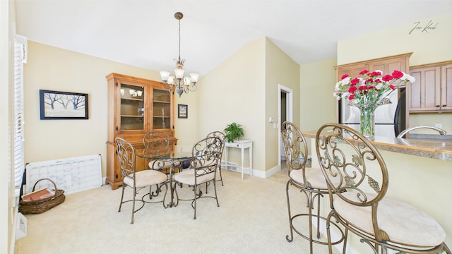 dining area with a chandelier, light carpet, and vaulted ceiling