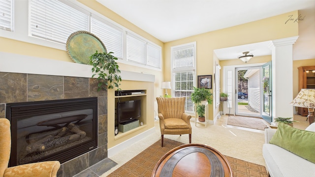 living area with a fireplace, carpet, and baseboards