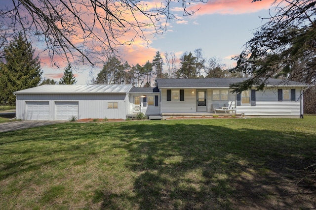 single story home with a front lawn and driveway