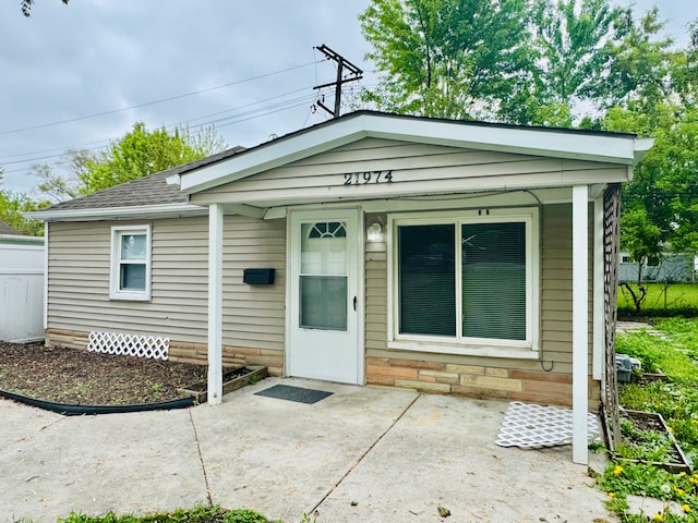21974 Elroy Ave, Warren, MI 48089 - view of front facade featuring a patio and roof with shingles