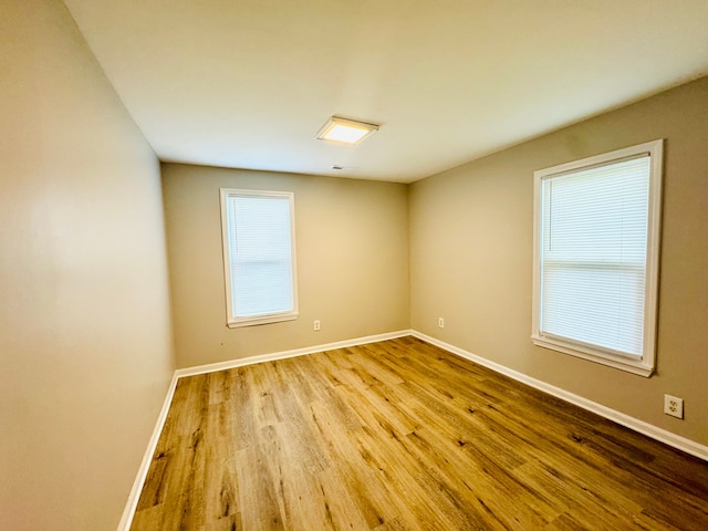 21974 Elroy Ave, Warren, MI 48089 - empty room with wood finished floors and baseboards