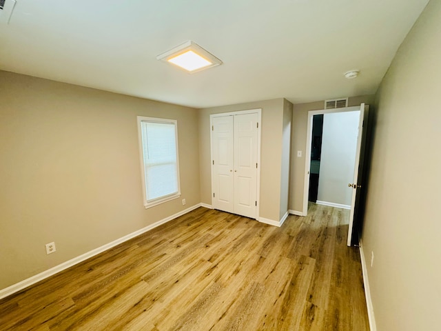 21974 Elroy Ave, Warren, MI 48089 - unfurnished bedroom with wood finished floors, baseboards, and a closet