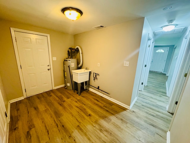 21974 Elroy Ave, Warren, MI 48089 - foyer featuring electric water heater, wood finished floors, and baseboards