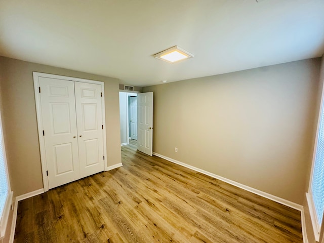 21974 Elroy Ave, Warren, MI 48089 - unfurnished bedroom featuring baseboards, wood finished floors, and a closet