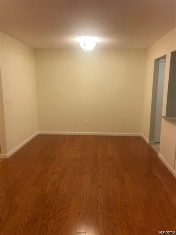 27915 Berrywood Ln Unit 72, Farmington Hills, MI 48334 - empty room featuring wood finished floors and baseboards