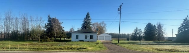 view of front of home with a detached garage