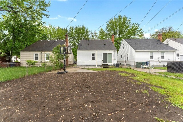 back of property featuring a fenced backyard, cooling unit, and a patio