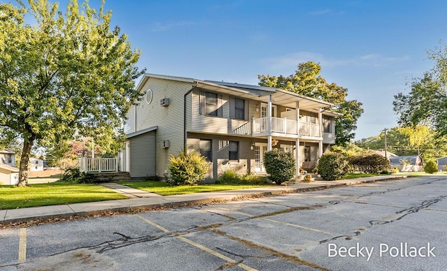 15278 Krueger St Unit 3, Spring Lake, MI 49456 - view of front of home with a balcony, a front yard, and uncovered parking