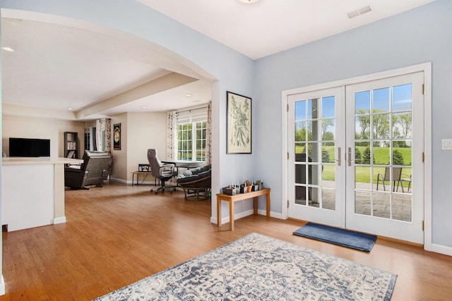 entryway featuring french doors, wood finished floors, baseboards, and recessed lighting