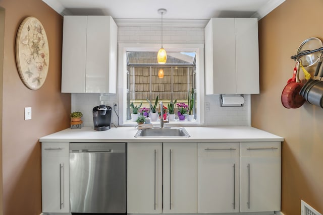 kitchen featuring stainless steel dishwasher, a sink, tasteful backsplash, white cabinets, and ornamental molding