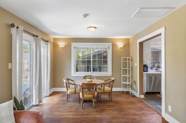dining space with dark wood-type flooring and baseboards