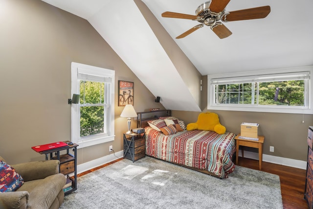 bedroom with baseboards, vaulted ceiling, wood finished floors, and ceiling fan