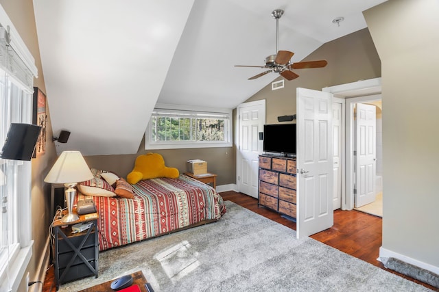 bedroom featuring lofted ceiling, wood finished floors, baseboards, and ceiling fan