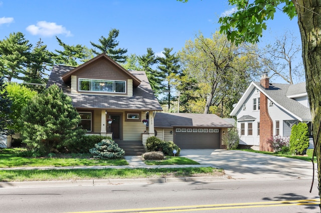 view of front of property featuring driveway, covered porch, and a garage