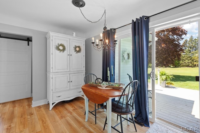 4730 Occidental Hwy, Adrian, MI 49221 - dining area featuring a chandelier, light wood-style floors, and a barn door