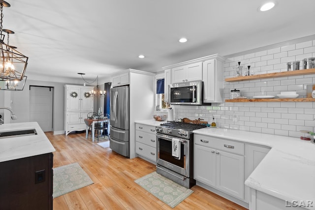 4730 Occidental Hwy, Adrian, MI 49221 - kitchen with stainless steel appliances, a chandelier, a sink, tasteful backsplash, and recessed lighting