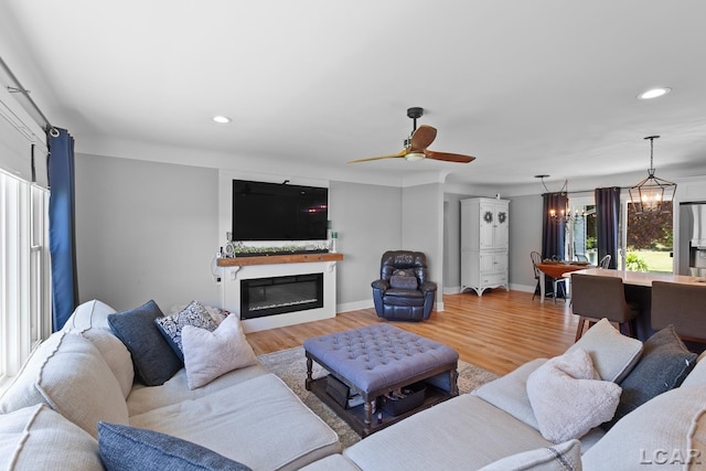 4730 Occidental Hwy, Adrian, MI 49221 - living room with wood finished floors, recessed lighting, a glass covered fireplace, a ceiling fan, and baseboards
