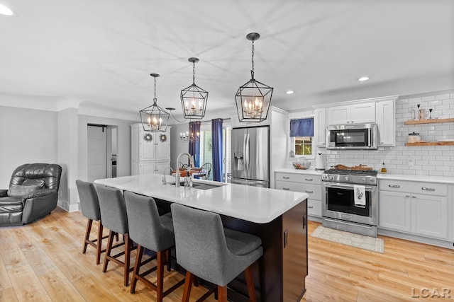 4730 Occidental Hwy, Adrian, MI 49221 - kitchen with stainless steel appliances, a sink, a chandelier, light countertops, and backsplash