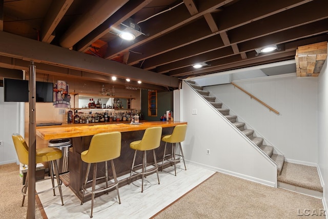 4730 Occidental Hwy, Adrian, MI 49221 - indoor dry bar with stairs, baseboards, and wood finished floors