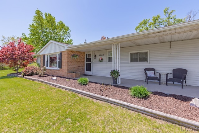4730 Occidental Hwy, Adrian, MI 49221 - single story home with a front yard, brick siding, and a porch