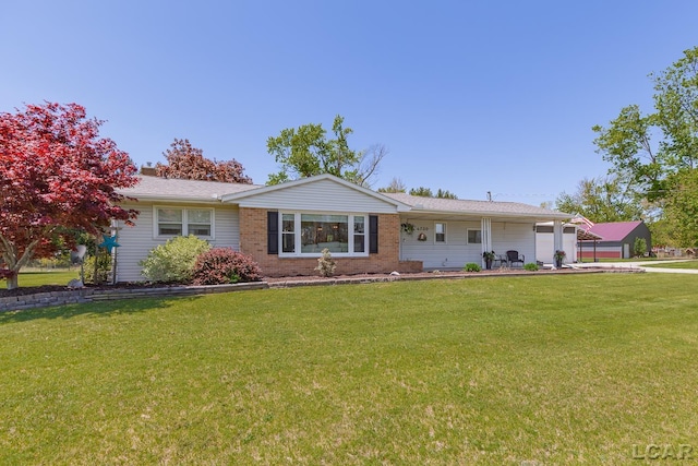 4730 Occidental Hwy, Adrian, MI 49221 - single story home with a front yard, brick siding, and concrete driveway