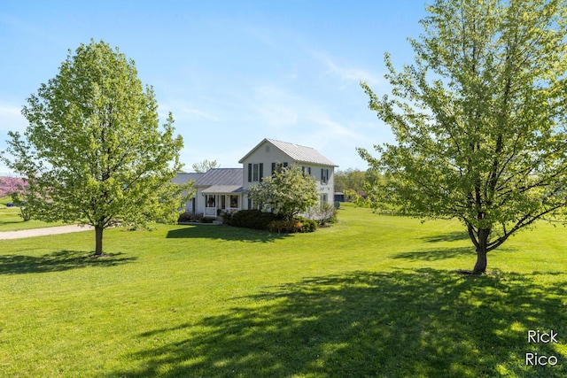 view of front of property with a front yard and metal roof