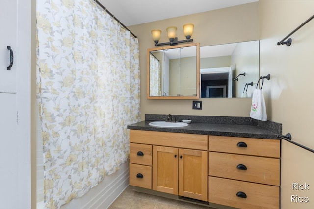 full bathroom featuring vanity and tile patterned flooring